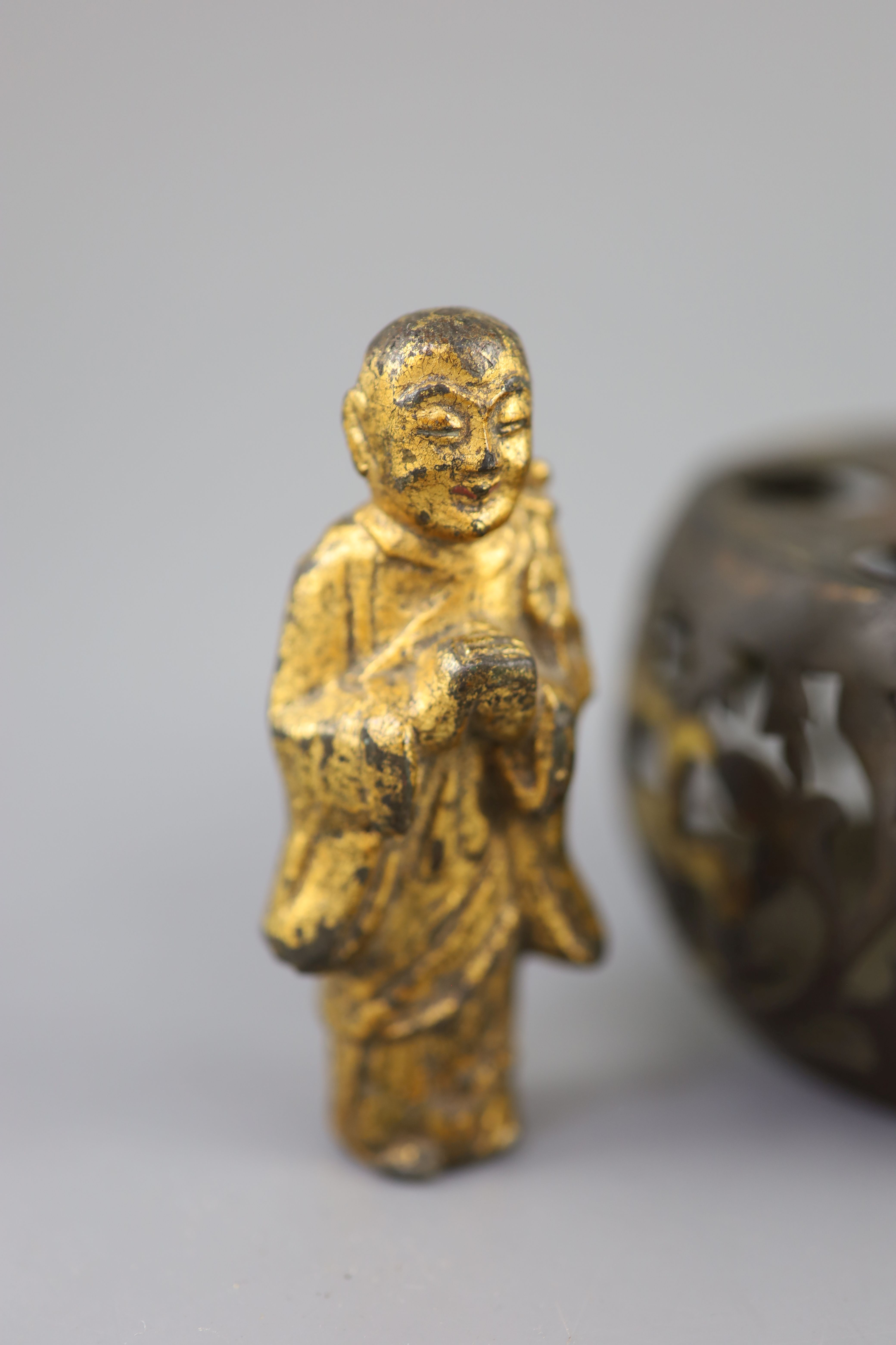 A Chinese bronze drum-shaped stand, a gilt bronze figure of a monk, 17th/18th century and a silver and gold inlaid iron waterpot, Qing,